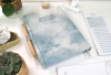 personalisierter Buchkalender in hellem Blau mit fühlbarem Struktureinband und zurückhaltenden, klaren Schriften